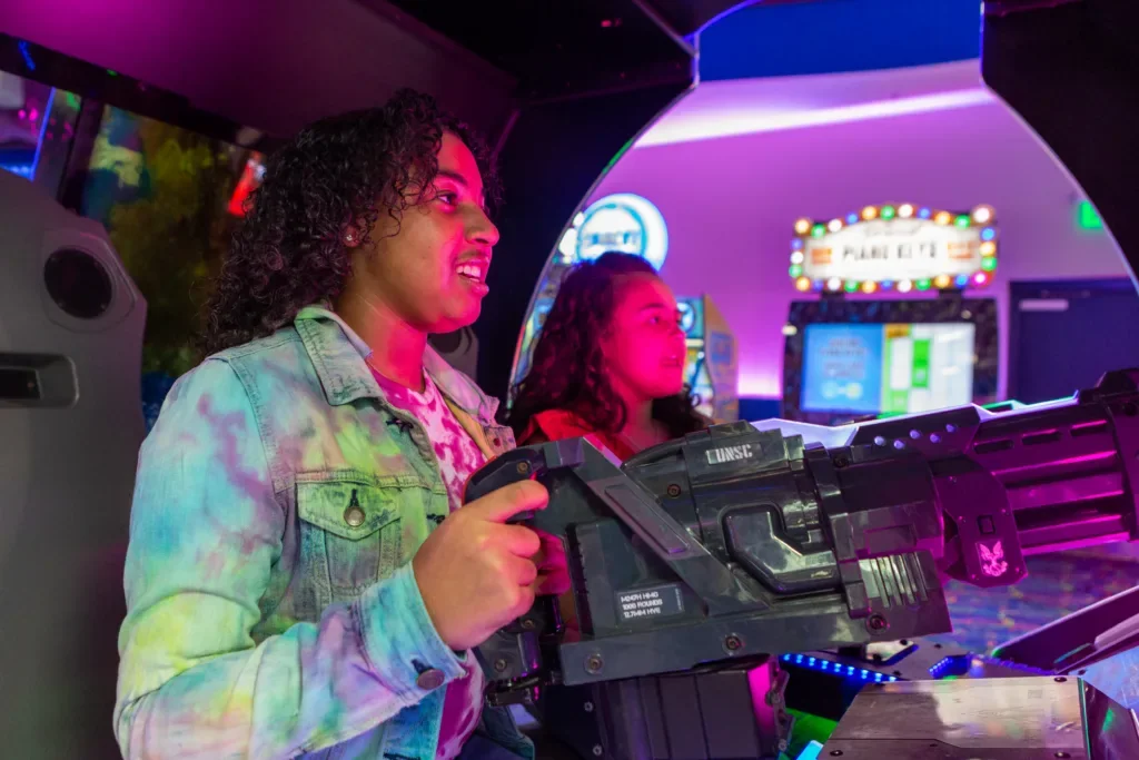 Friends playing interactive arcade games at Arcade City Gatlinburg